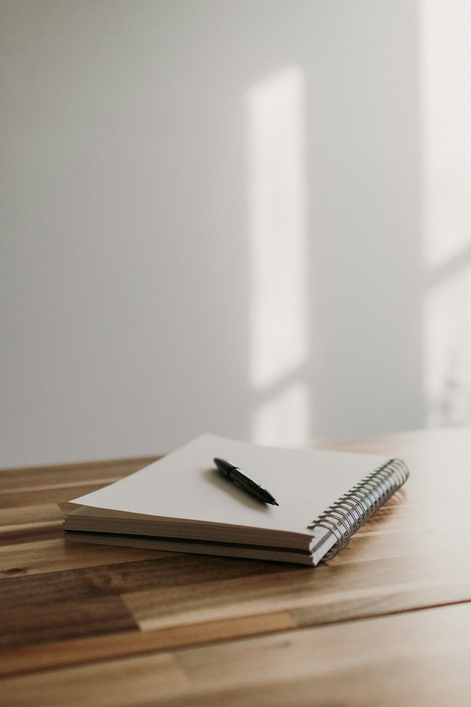 An open notebook with a pen ready for a short note