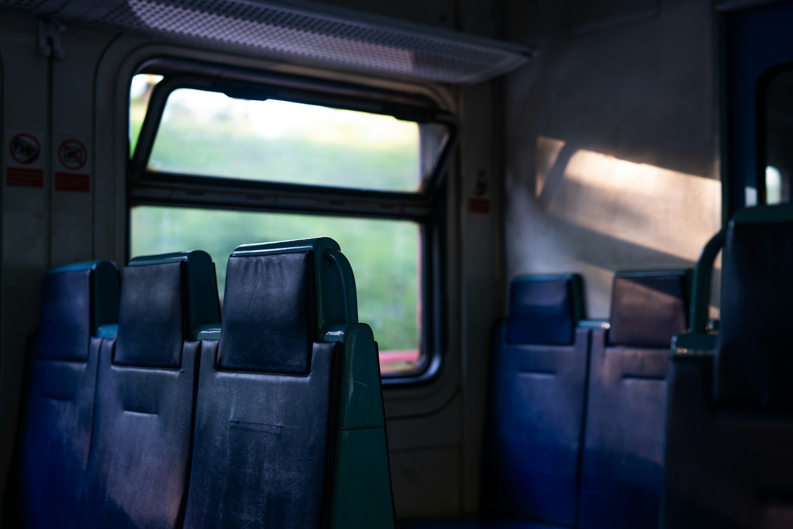 Seats beside a train carriage window